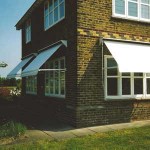 Drop arm awnings