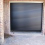 Outside black garage door with white frame inside